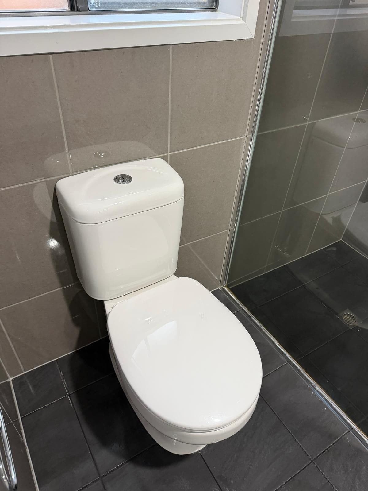 Sparkling white toilet and tiled shower after end of lease clean - Adelaide